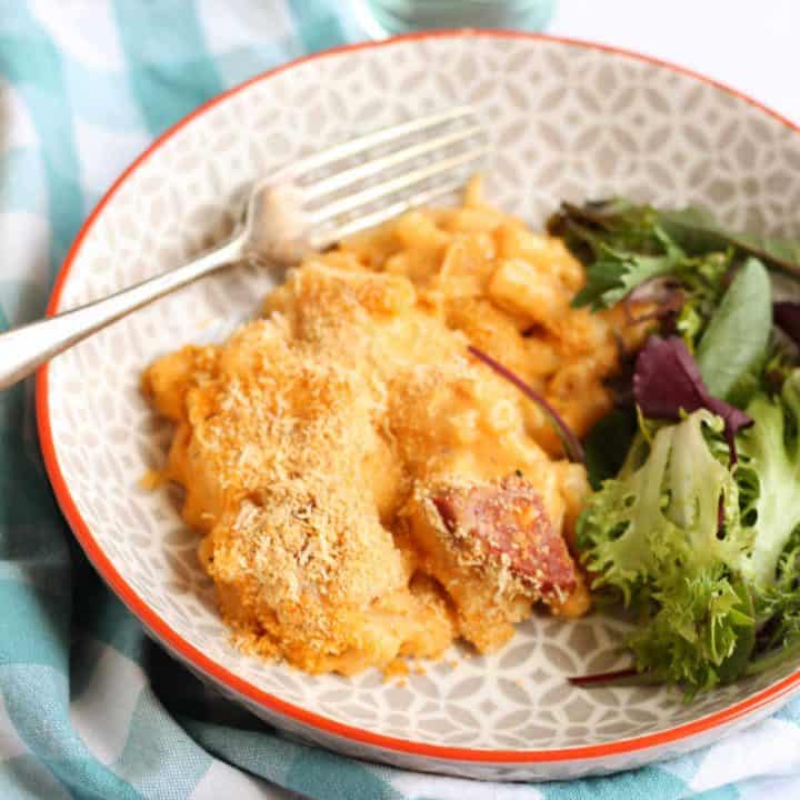 A bowl of Chorizo Mac and Cheese with side salad