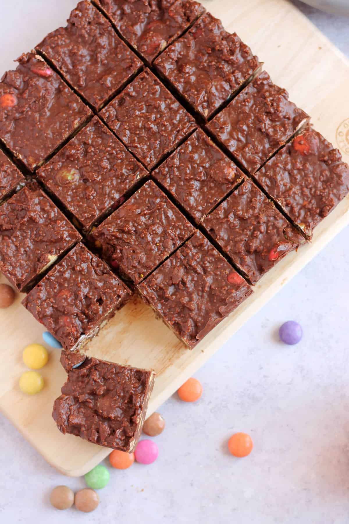 Overhead image of cut chocolate biscuit cake with smarties