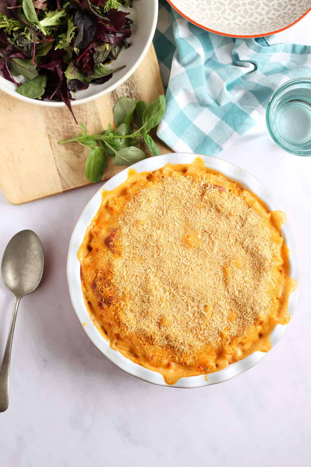 Overhead shot of a large macaroni cheese in a round serving dish.