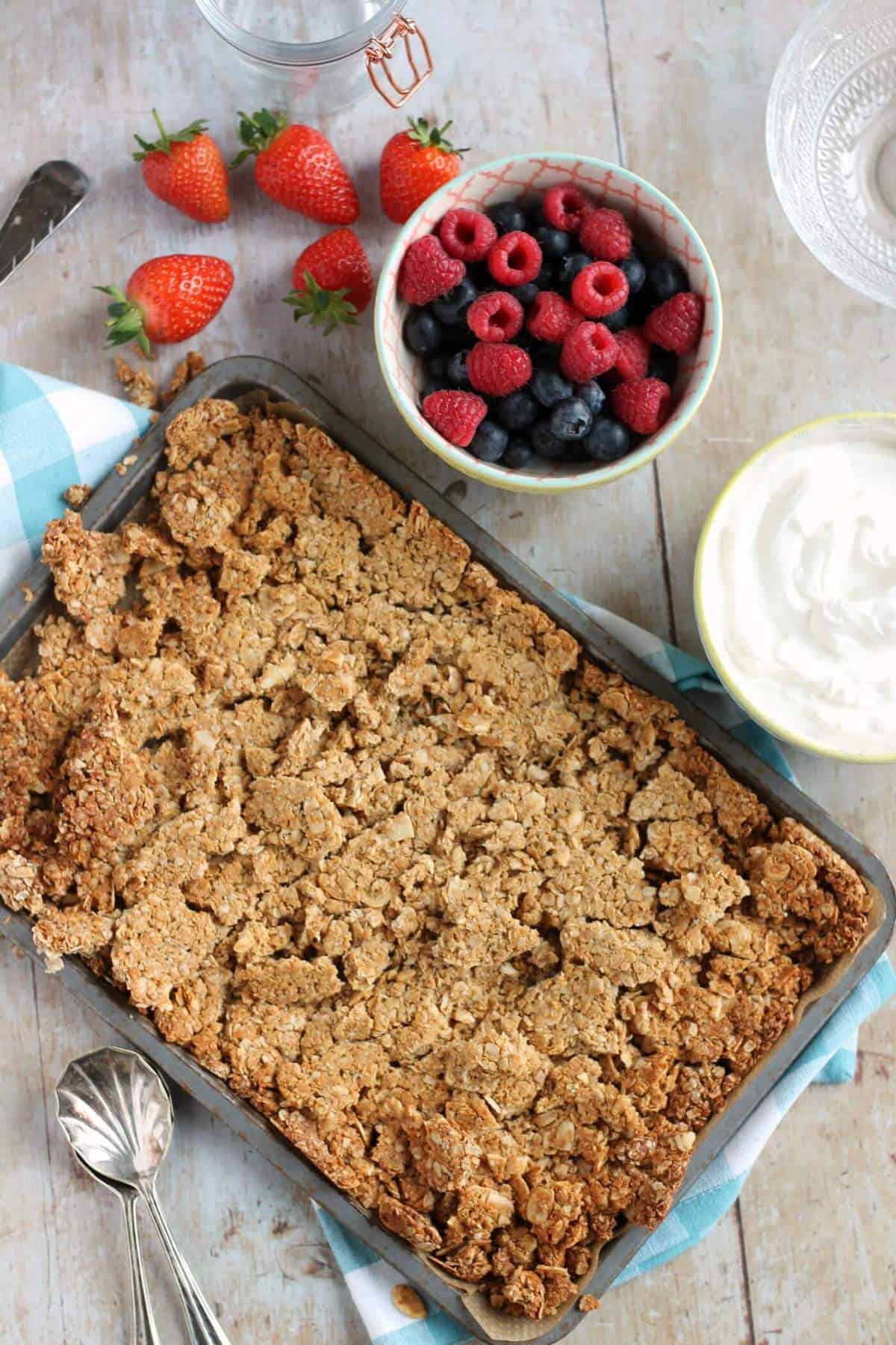 Overhead shot of peanut butter granola and fresh summer berries.