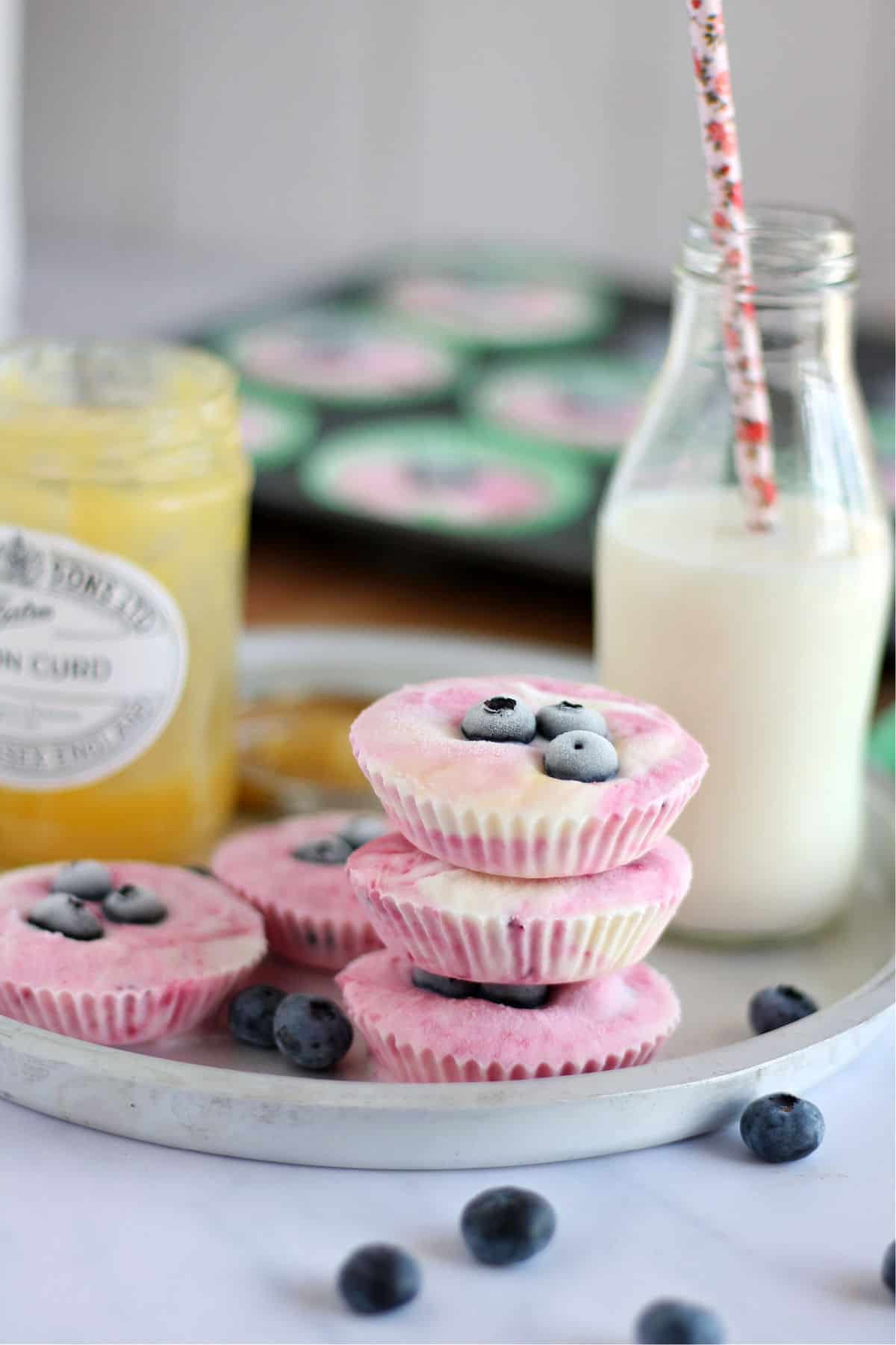 A stack of frozen fruity yogurt bites topped with blueberries