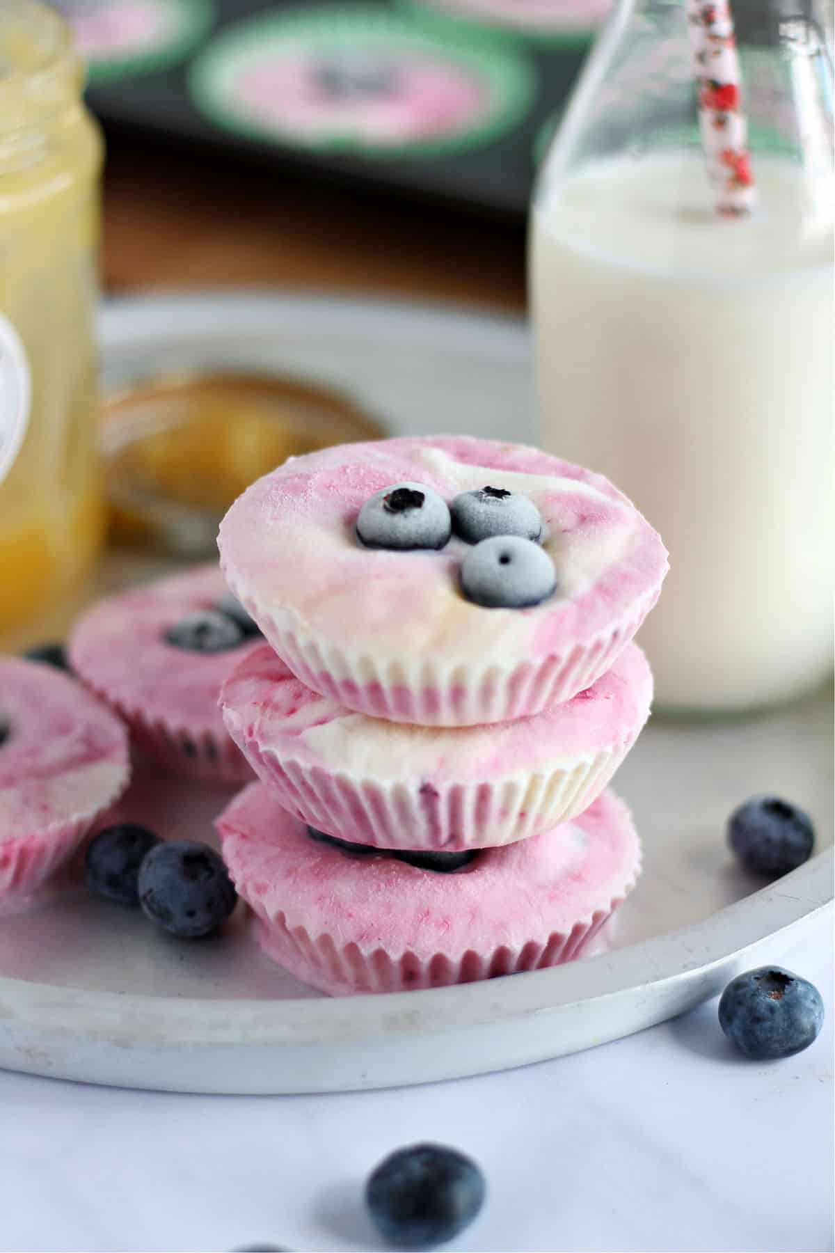 Close-up shot of the frozen yogurt bites with blueberries and lemon curd.