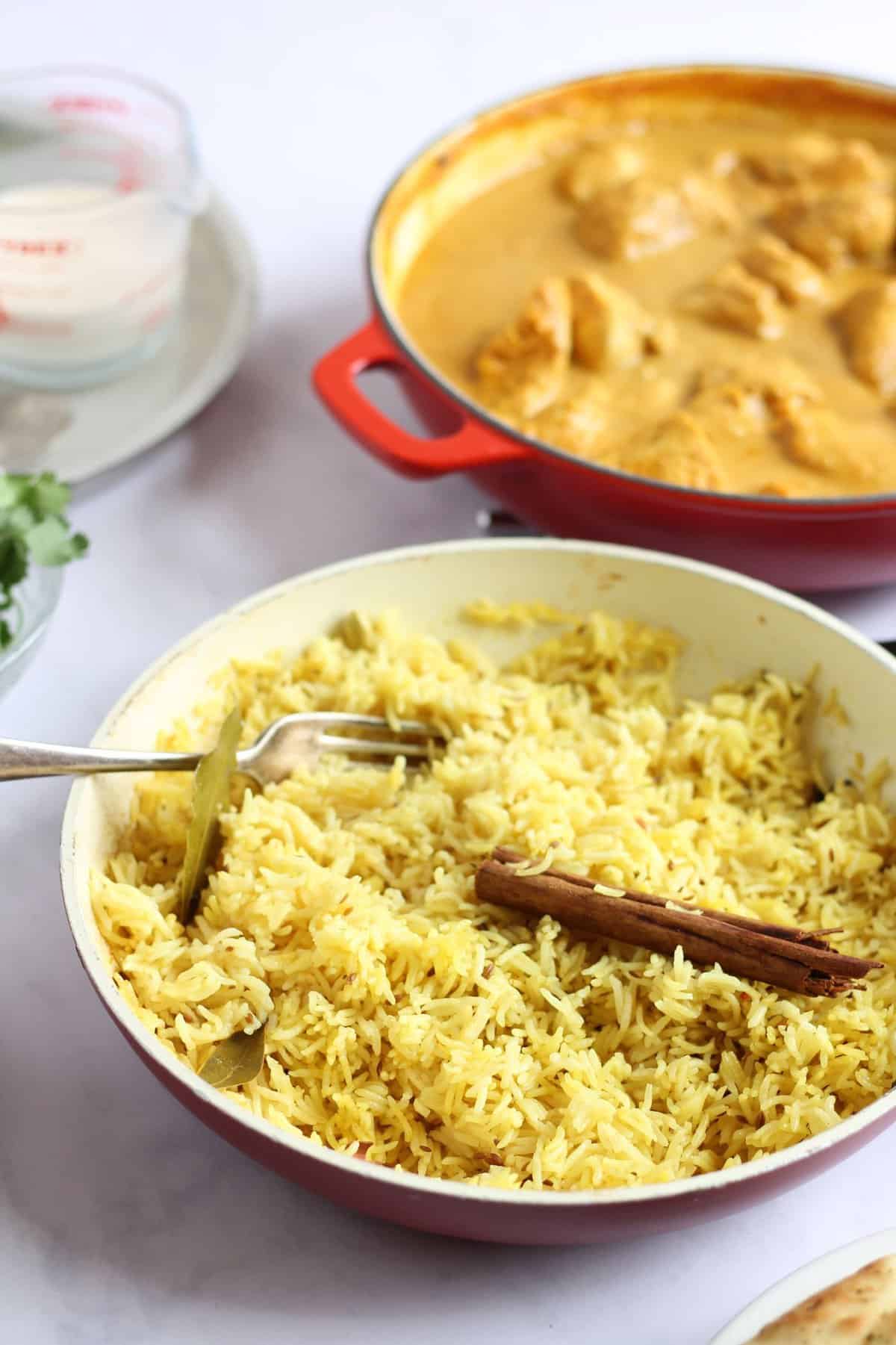 Homemade pilau rice in a pan as part of a curry feast.