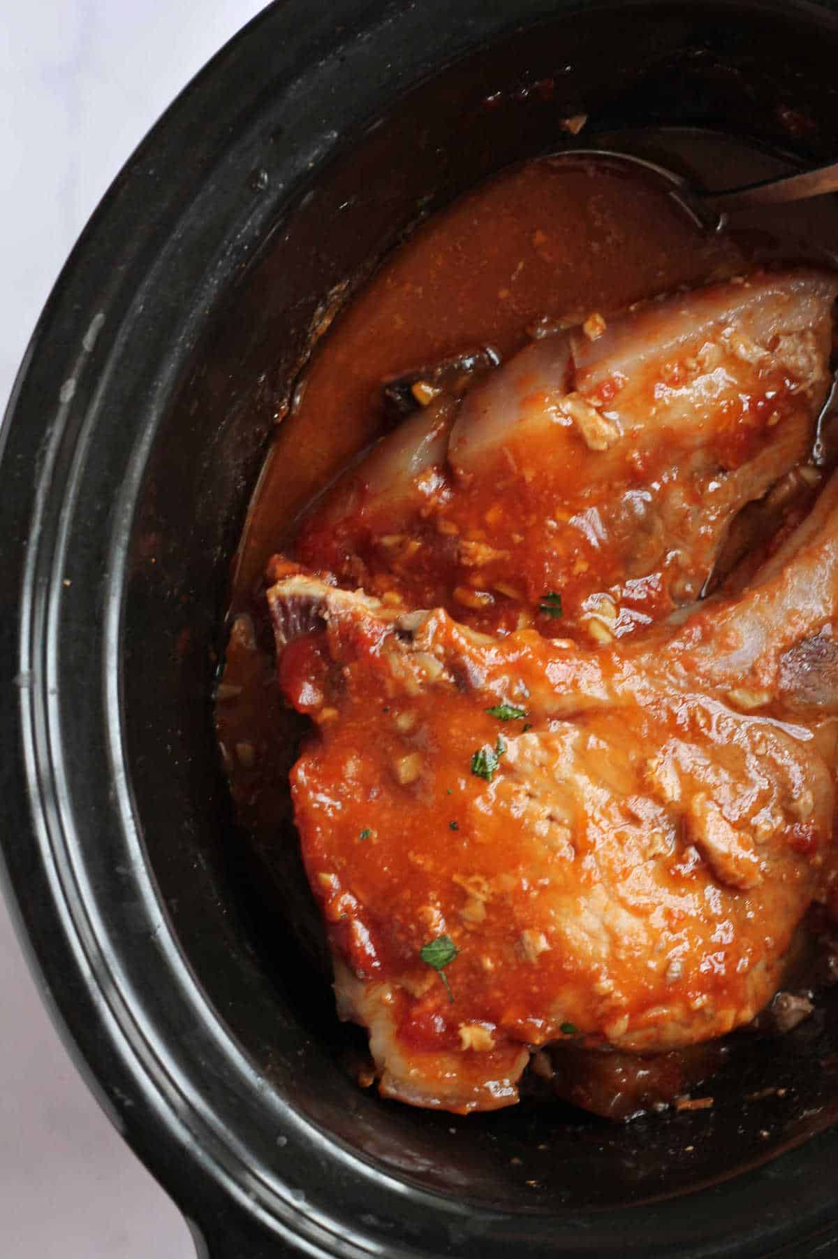 Slow cooker with honey garlic pork chops.