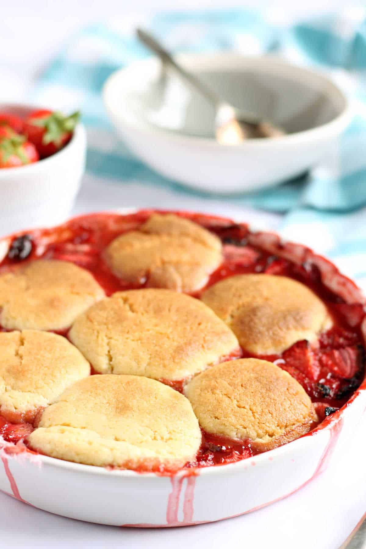 Strawberry Cobbler in a white dish.