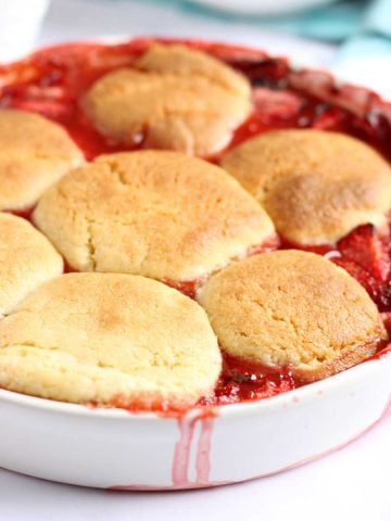 Strawberry cobbler in a white baking dish.