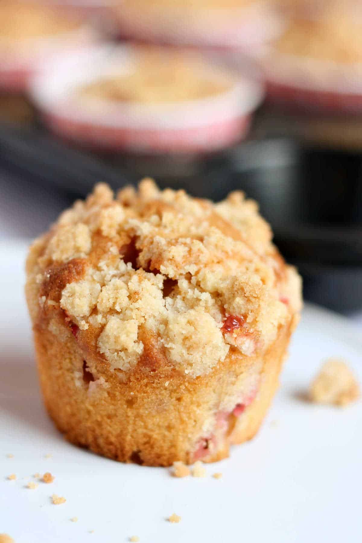 A close up of a muffin with streusel topping.