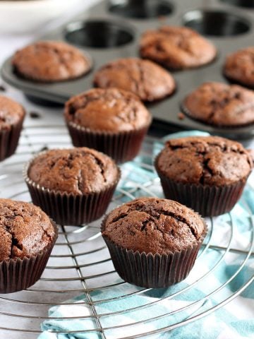 Chocolate courgette muffins om a cooling rack.