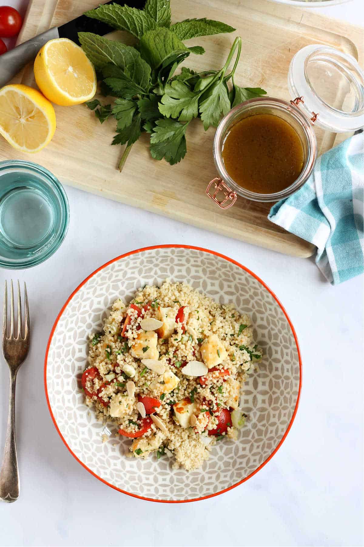 Overhead shot of couscous salad with salad dressing.