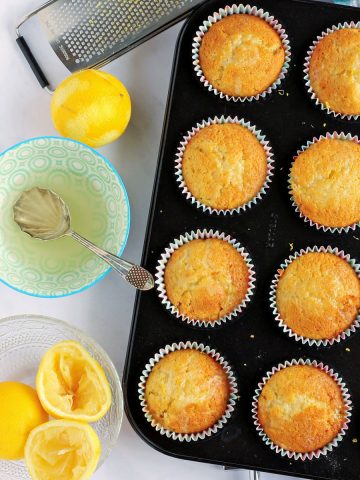 Lemon drizzle muffins in muffin tin.