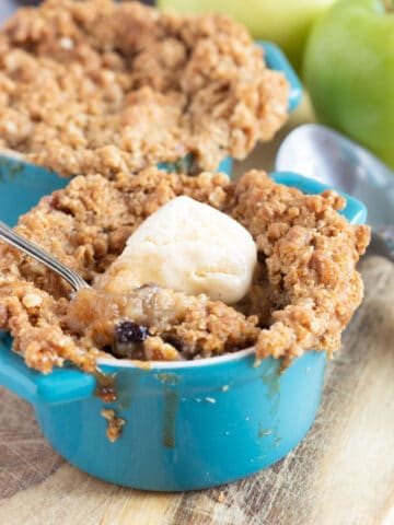 Individual apple and mincemeat crumbles in blue ramekins.