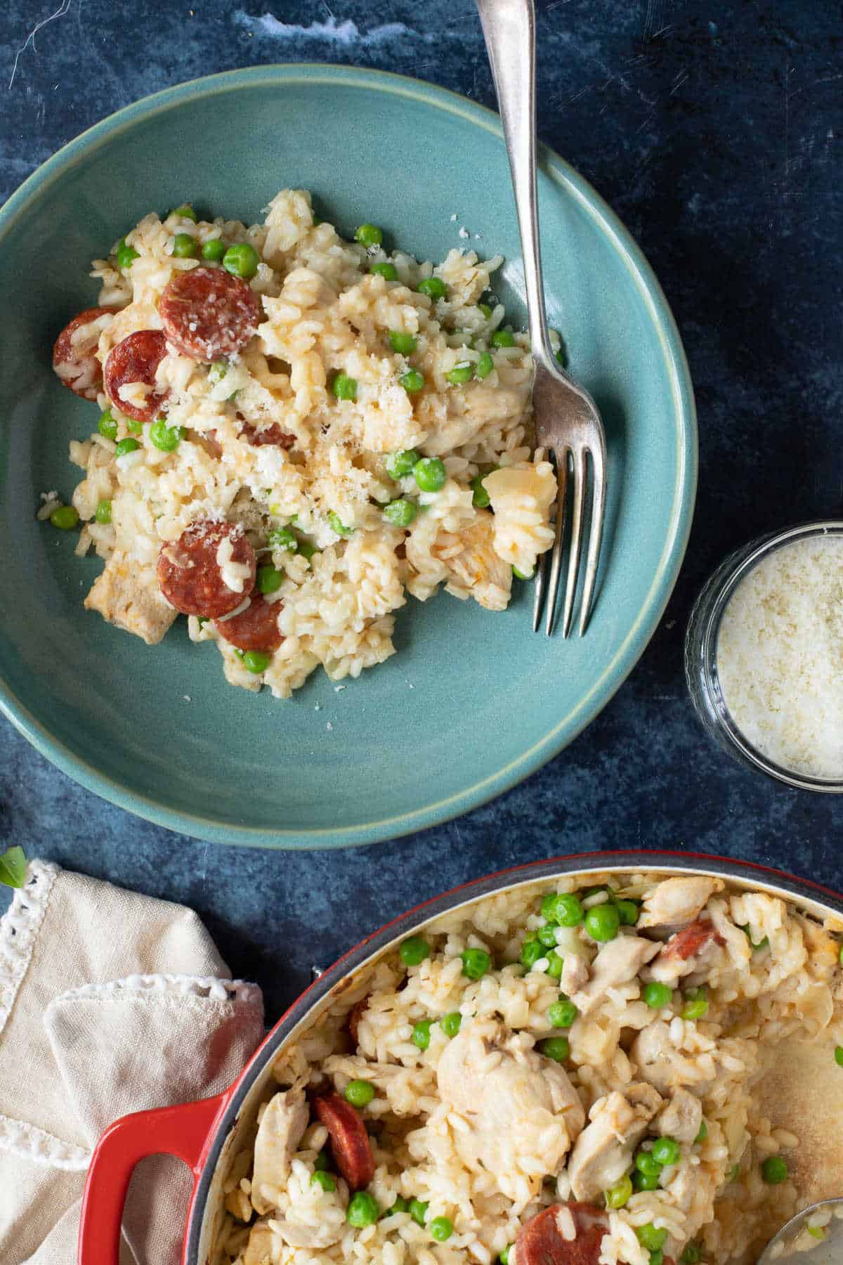 A bowl of oven baked risotto sprinkled with grated Parmesan.