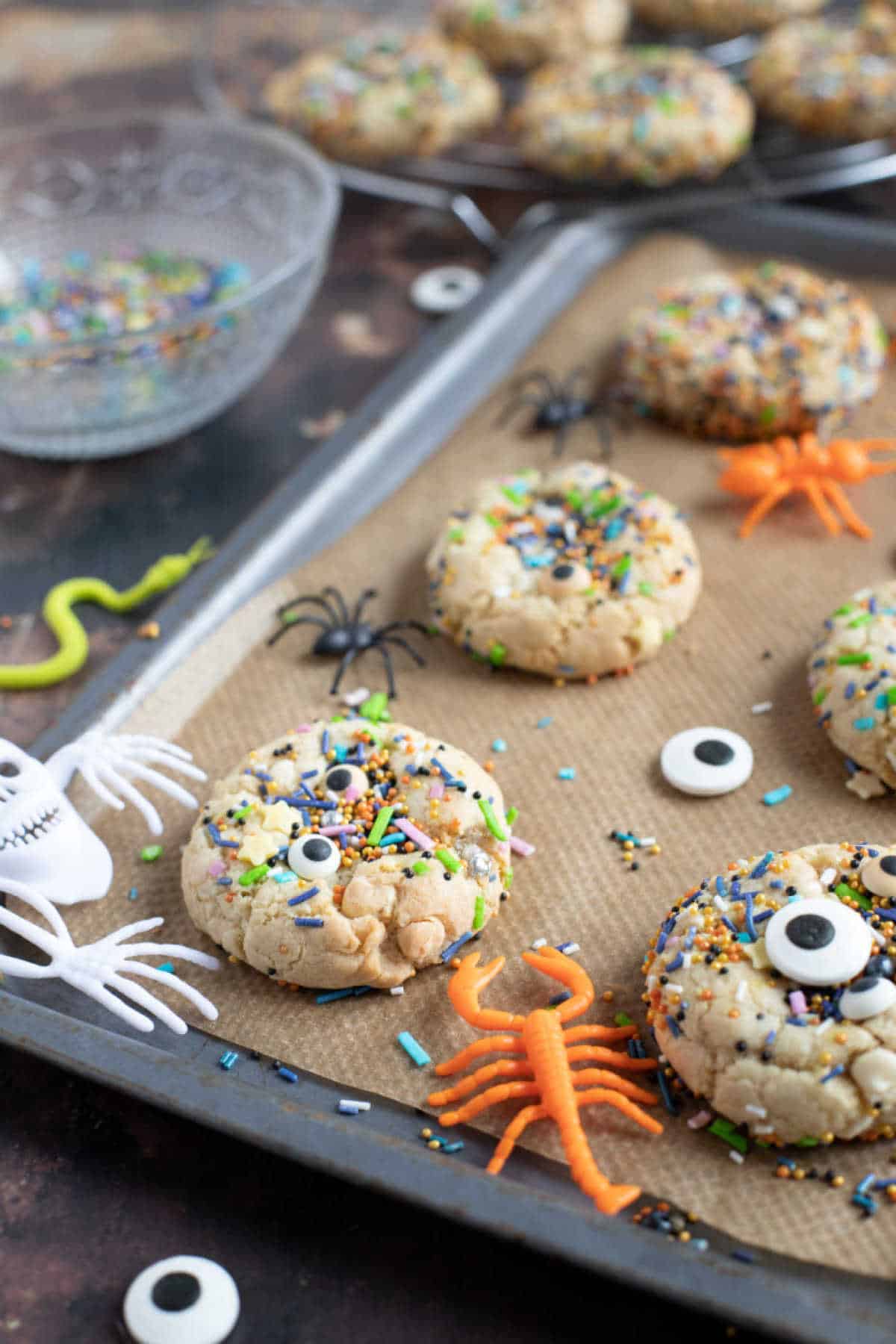 Halloween sprinkle cookies on a baking tray.