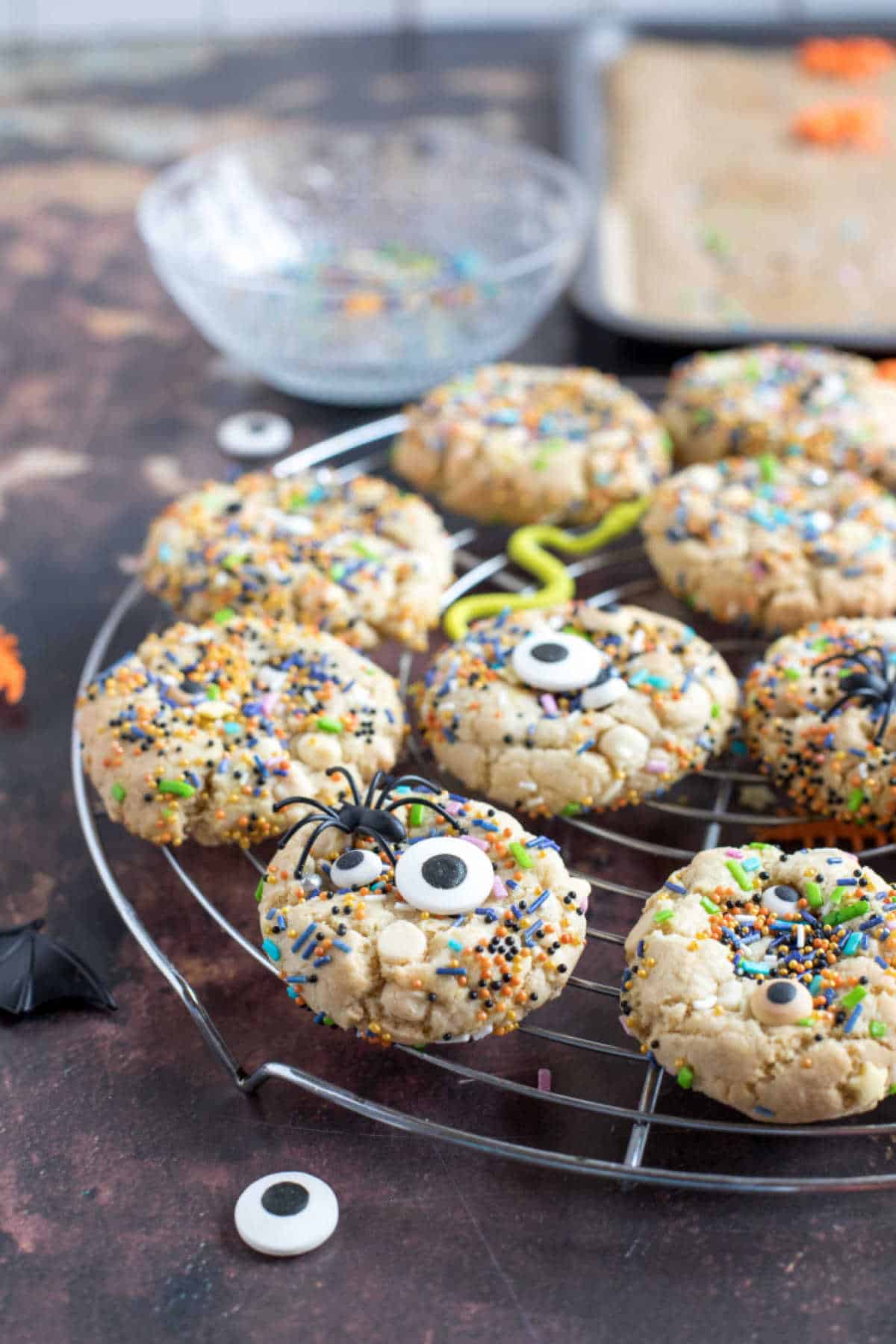 Halloween sprinkle cookies on a cooling rack.