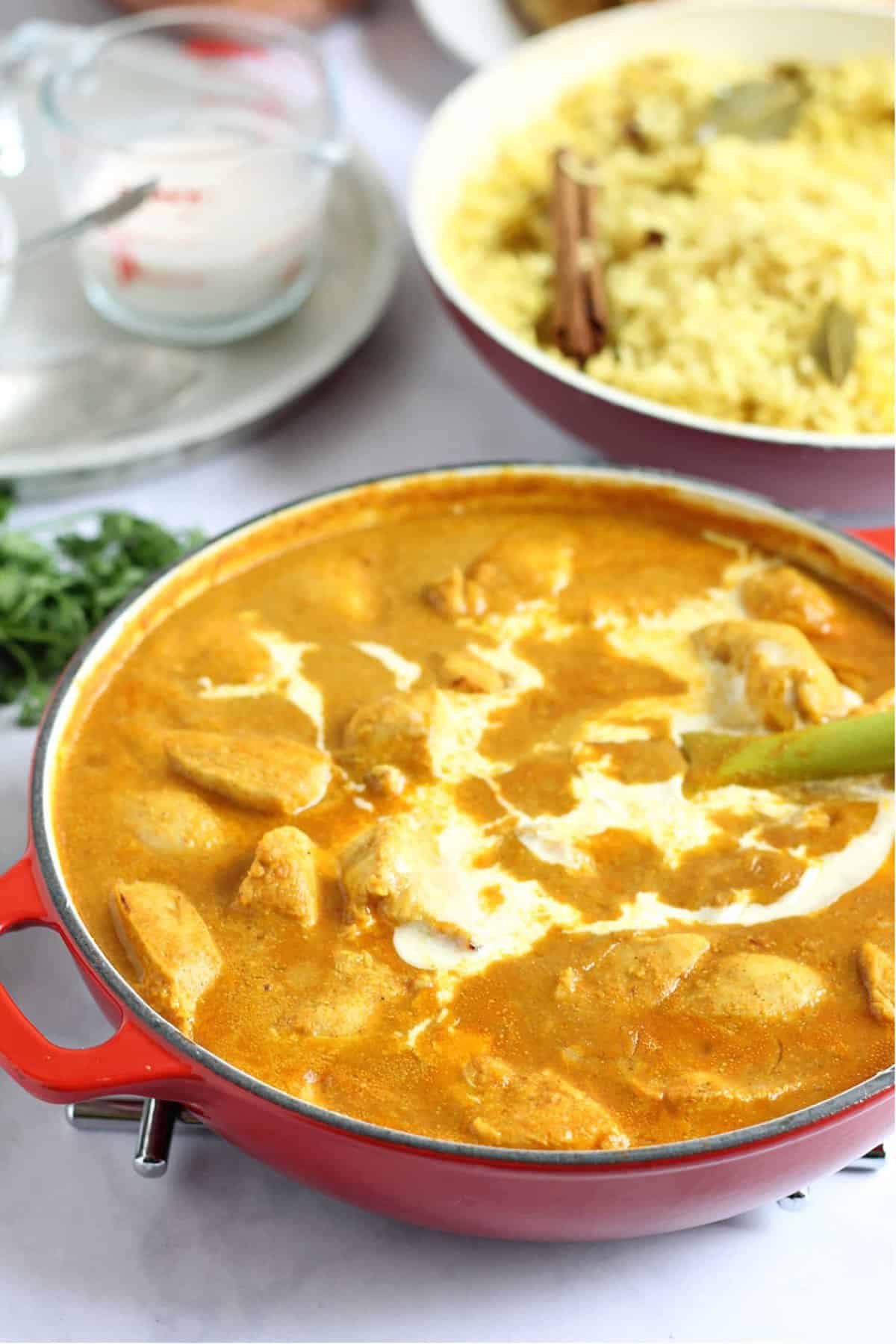 Mild chicken curry in a pan, drizzled with double cream.