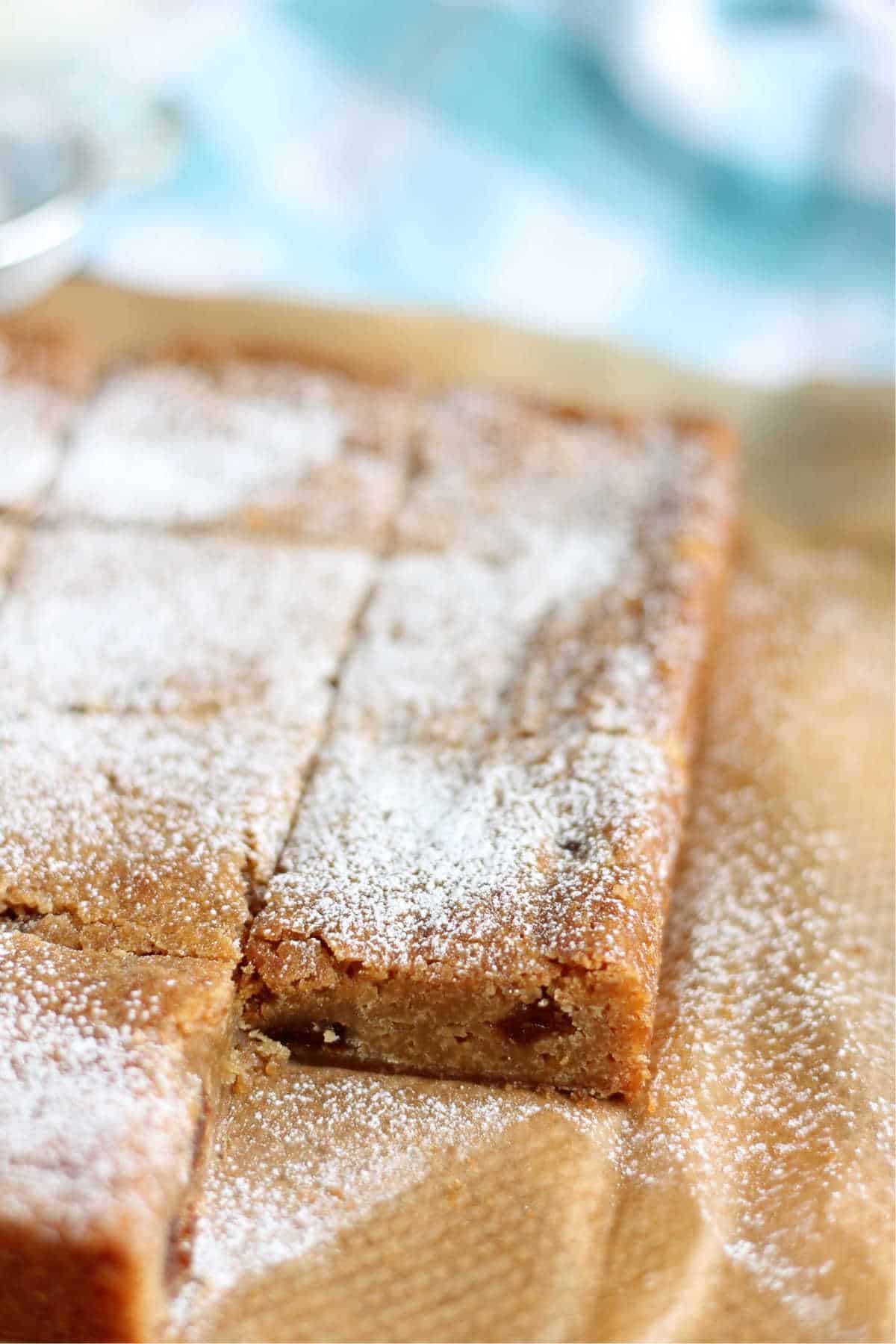 Mince pie blondies on a chopping board ready to be sliced.