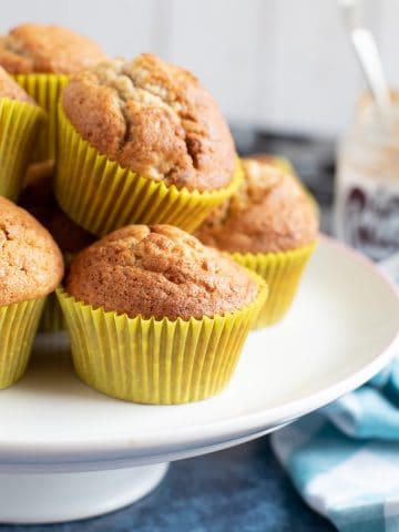 Banana and peanut butter muffins on a cake stand.