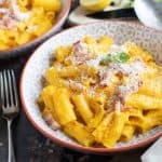 Bacon and pumpkin pasta in a bowl.