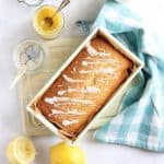 Lemon Curd Loaf Cake on a cake board ready for slicing.
