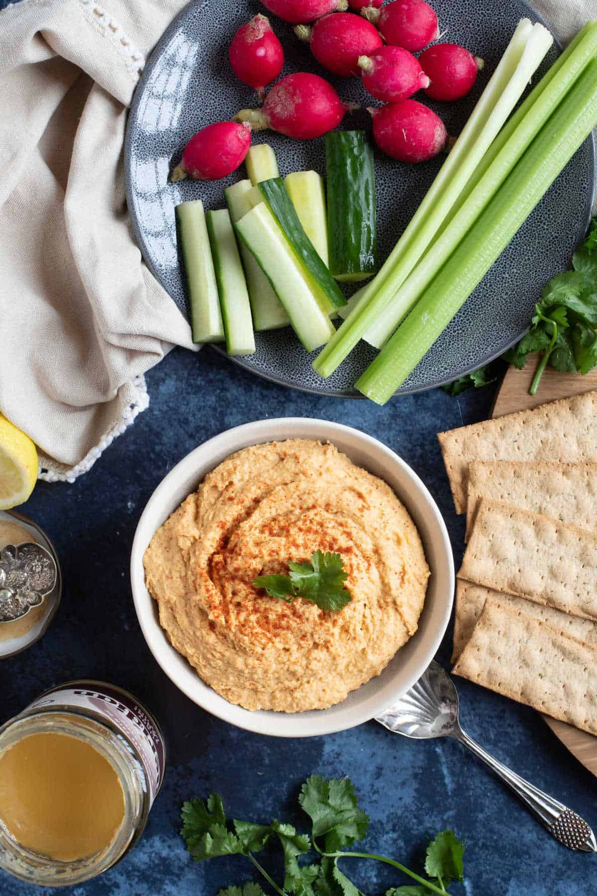 A bowl of homemade Moroccan hummus with fresh raw vegetables.