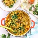 Sweet potato and lentil curry in a pan with mango chutney and coriander.