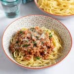 turkey bolognese in a bowl with grated parmesan.