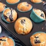 Blueberry and white chocolate muffins in a muffin tin.