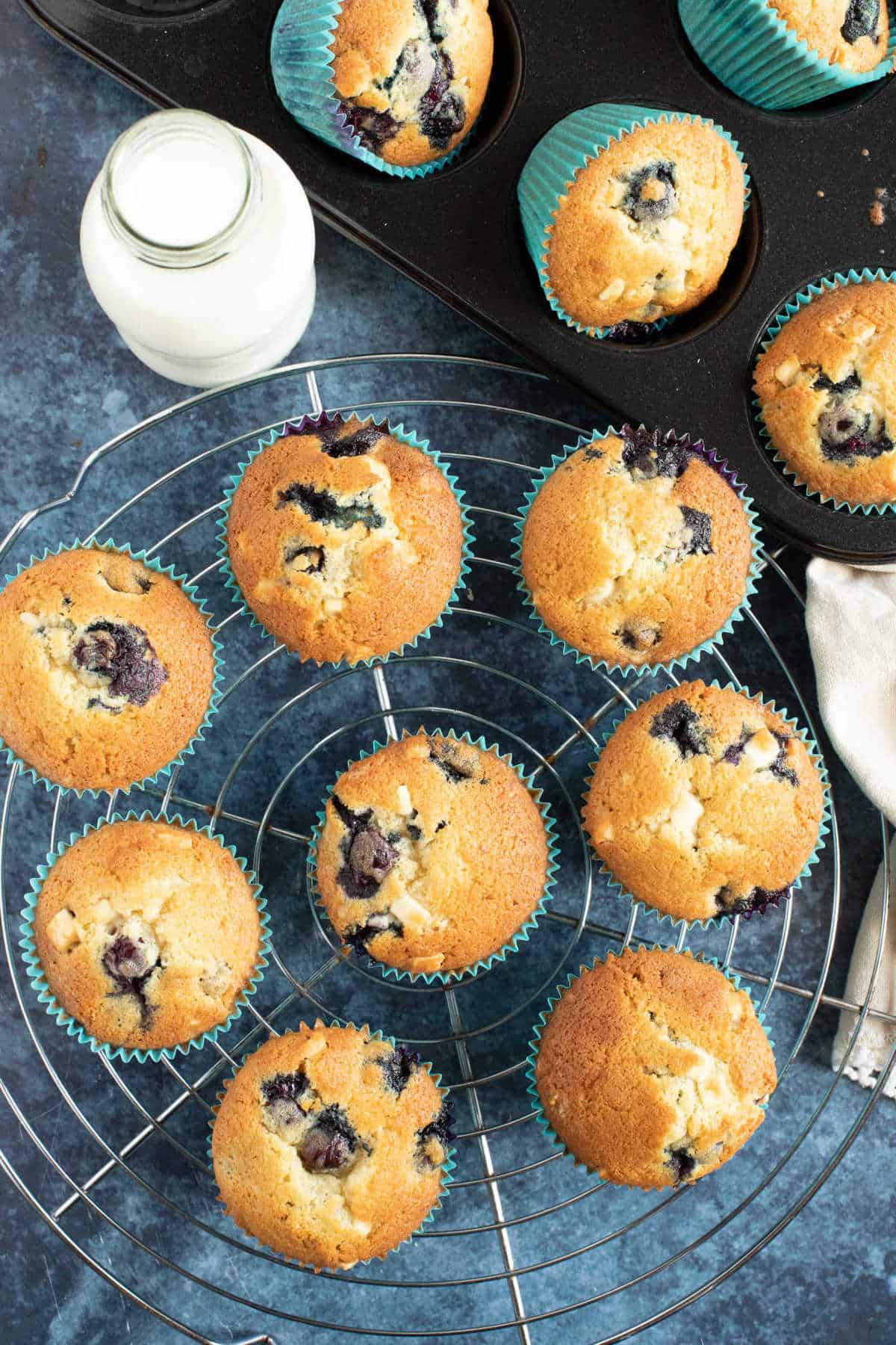 Blueberry muffins on a wire cooling rack.