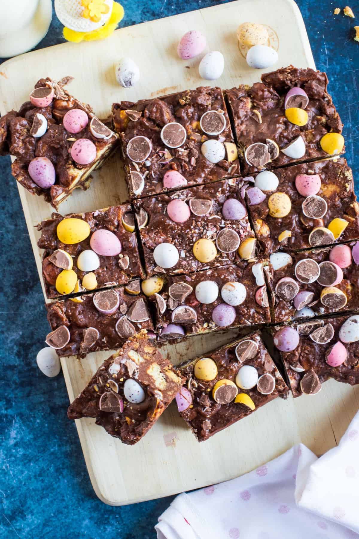 This no-bake chocolate mini egg tiffin is the perfect chocolate treat for Easter, or any time of year for that matter! Crushed digestive biscuits, melted dark and milk chocolate and sweet golden syrup encase the all-important Cadburys mini eggs in this decadent chocolate delight. Not for the faint-hearted, that's for sure!