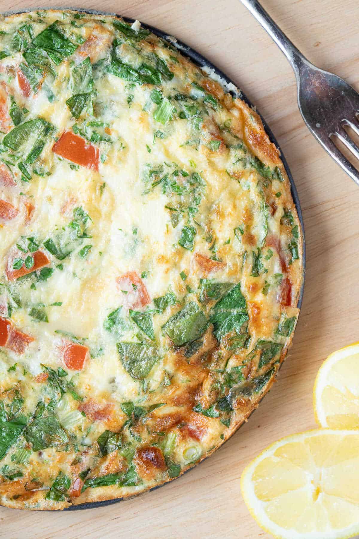 Close-up photo of a spinach feta  and tomato frittata