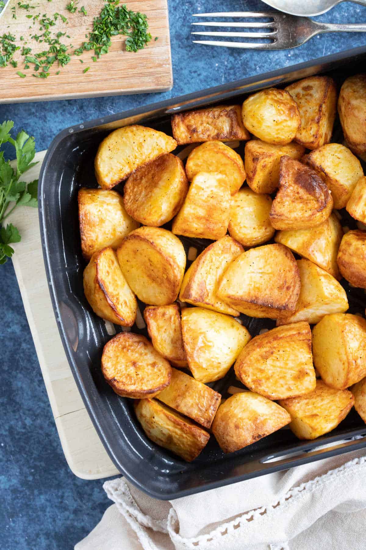 Roast potatoes in an air fryer basket.