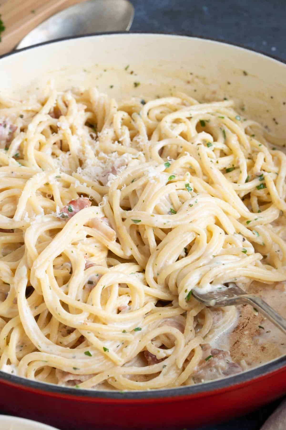 A pan of creamy Boursin pasta with bacon.