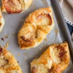 Cheese and bacon turnovers on a baking sheet.