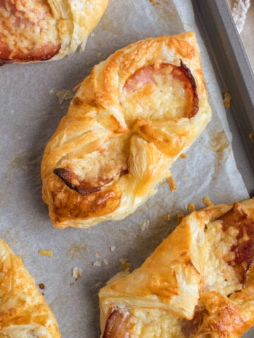 Cheese and bacon turnovers on a baking sheet.