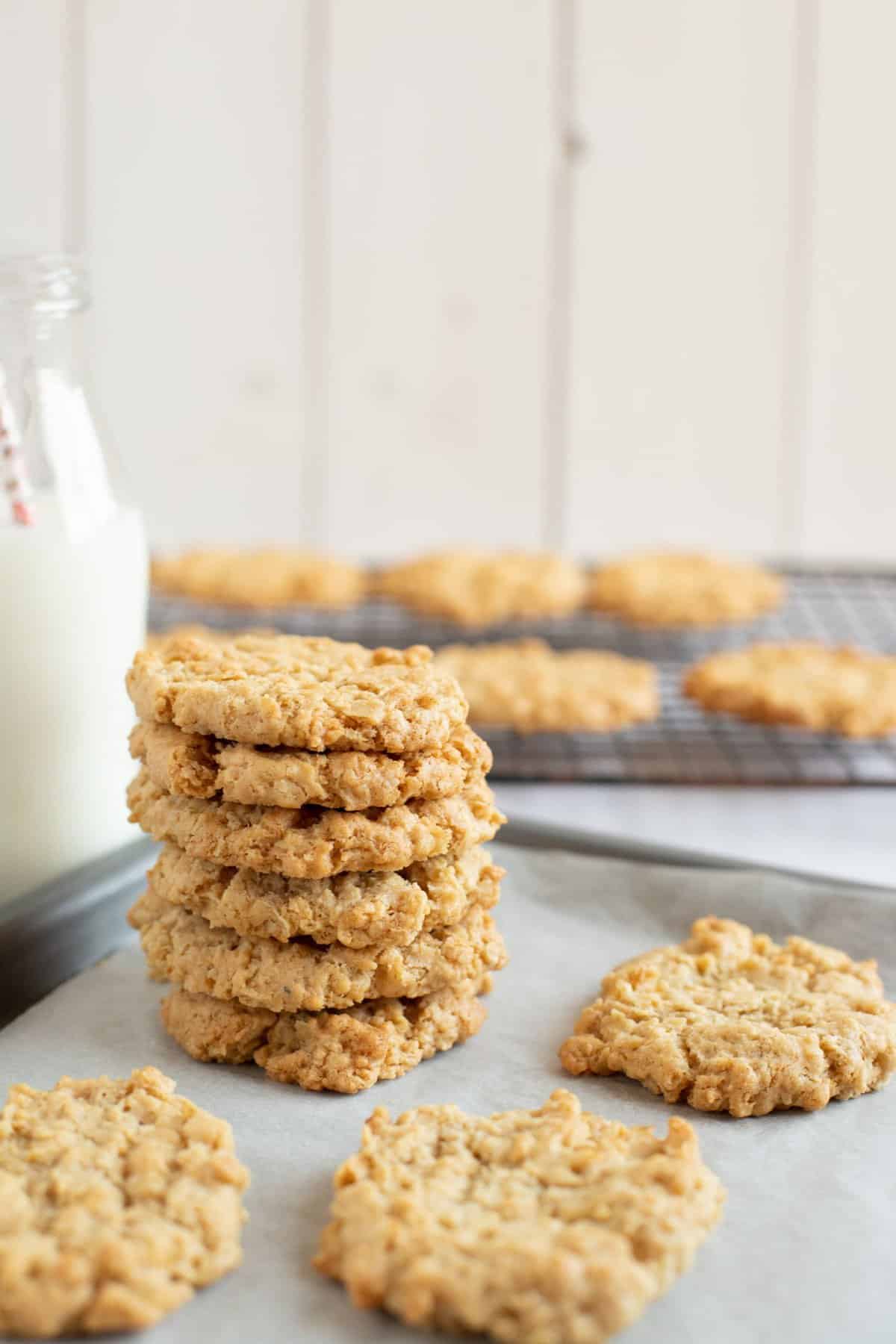 Cinnamon cookies stacked up on a baking tray.