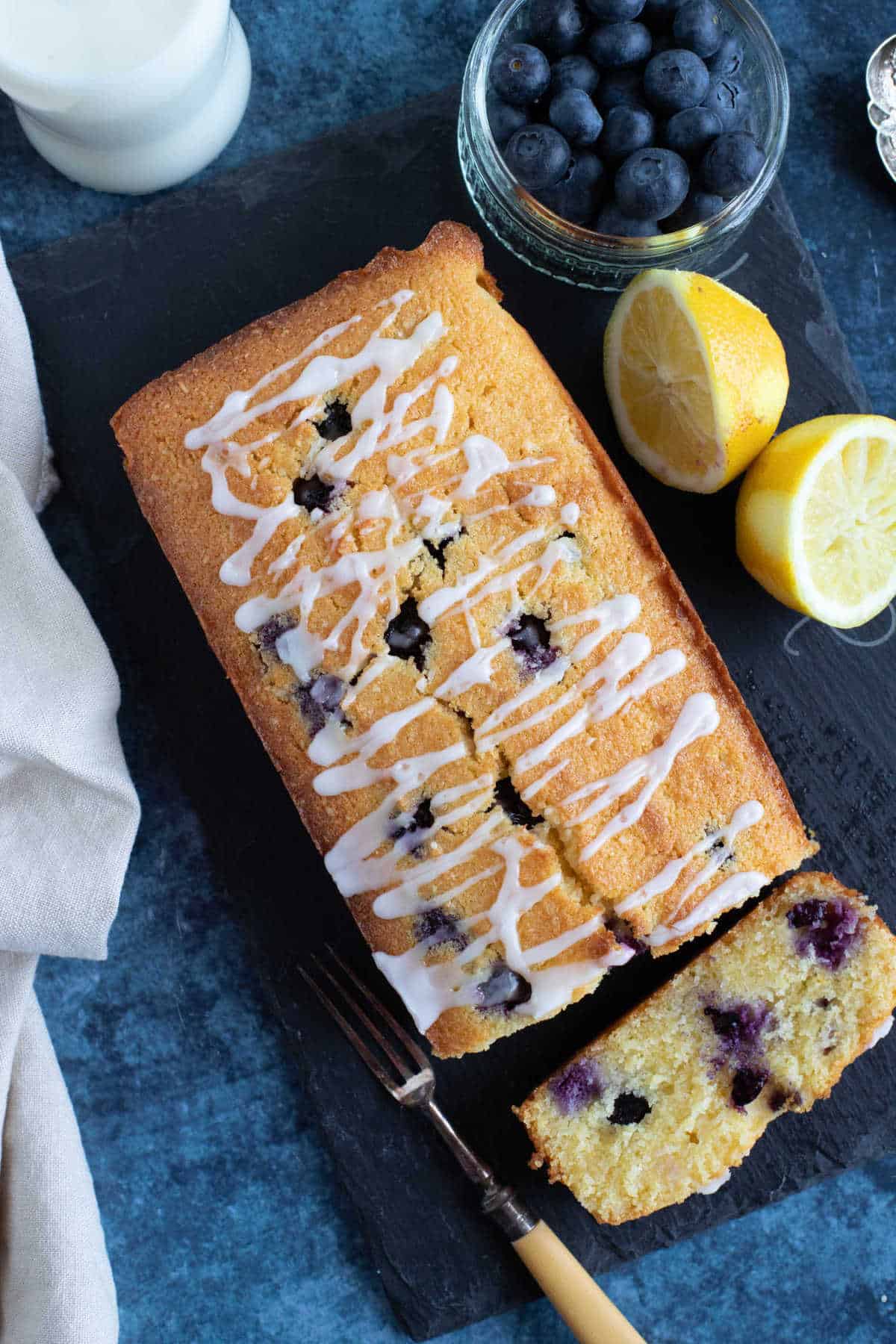 Overhead photo of lemon polenta loaf cake with blueberries.