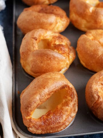 A tray of crispy golden Yorkshire puddings.