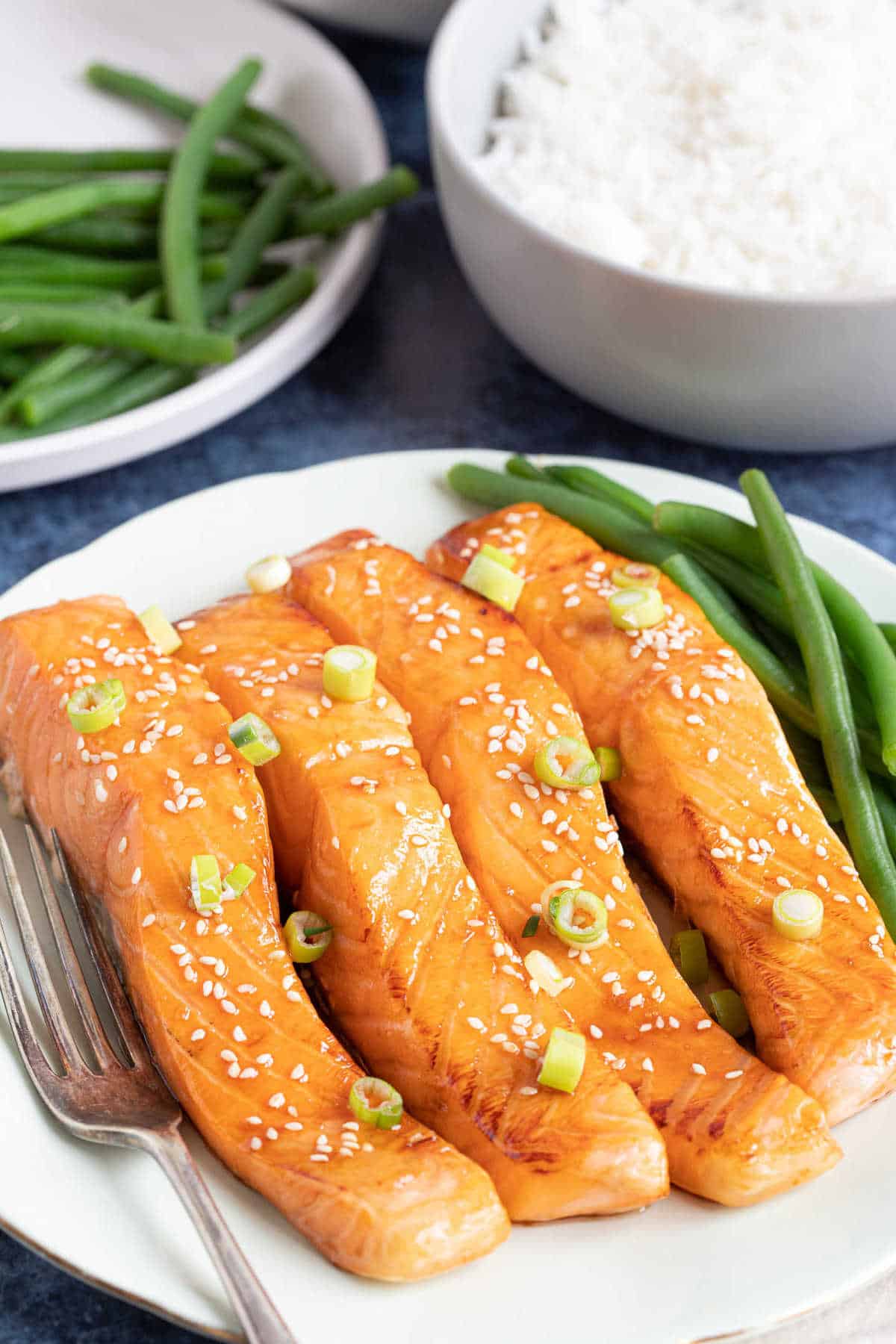 Air fryer salmon portions served with green beans.