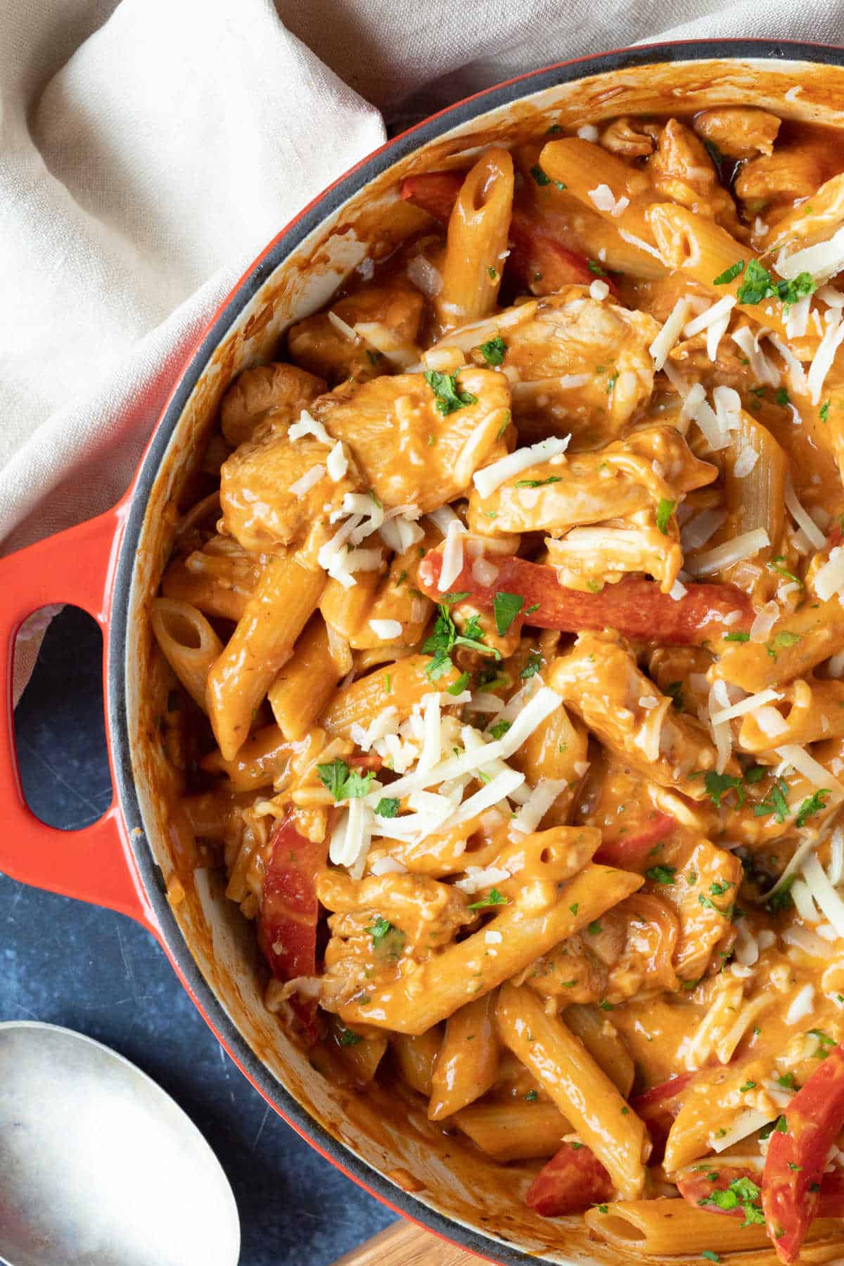 Creamy BBQ chicken pasta in a red casserole.