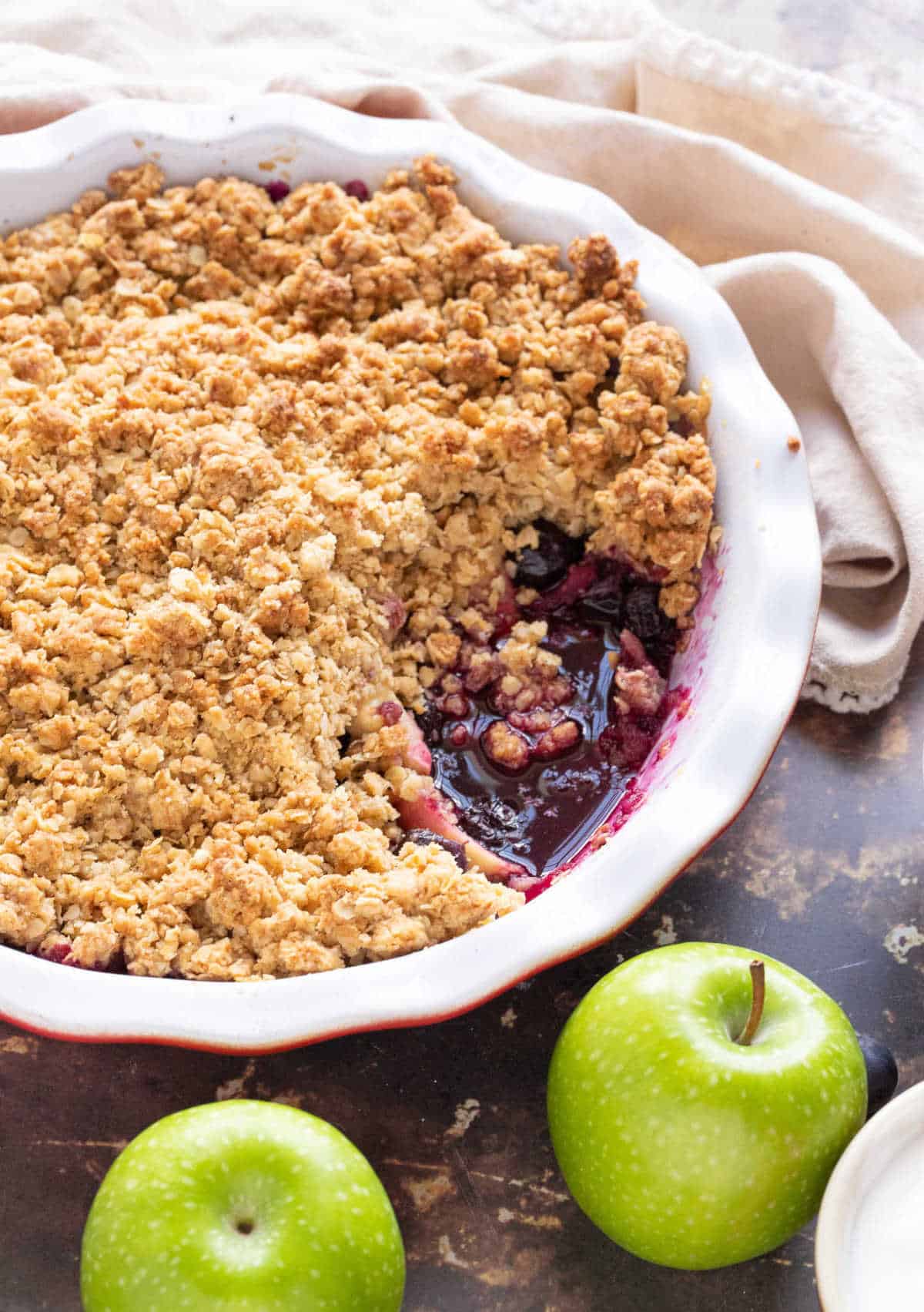 Apple and blueberry crumble in a pie dish.