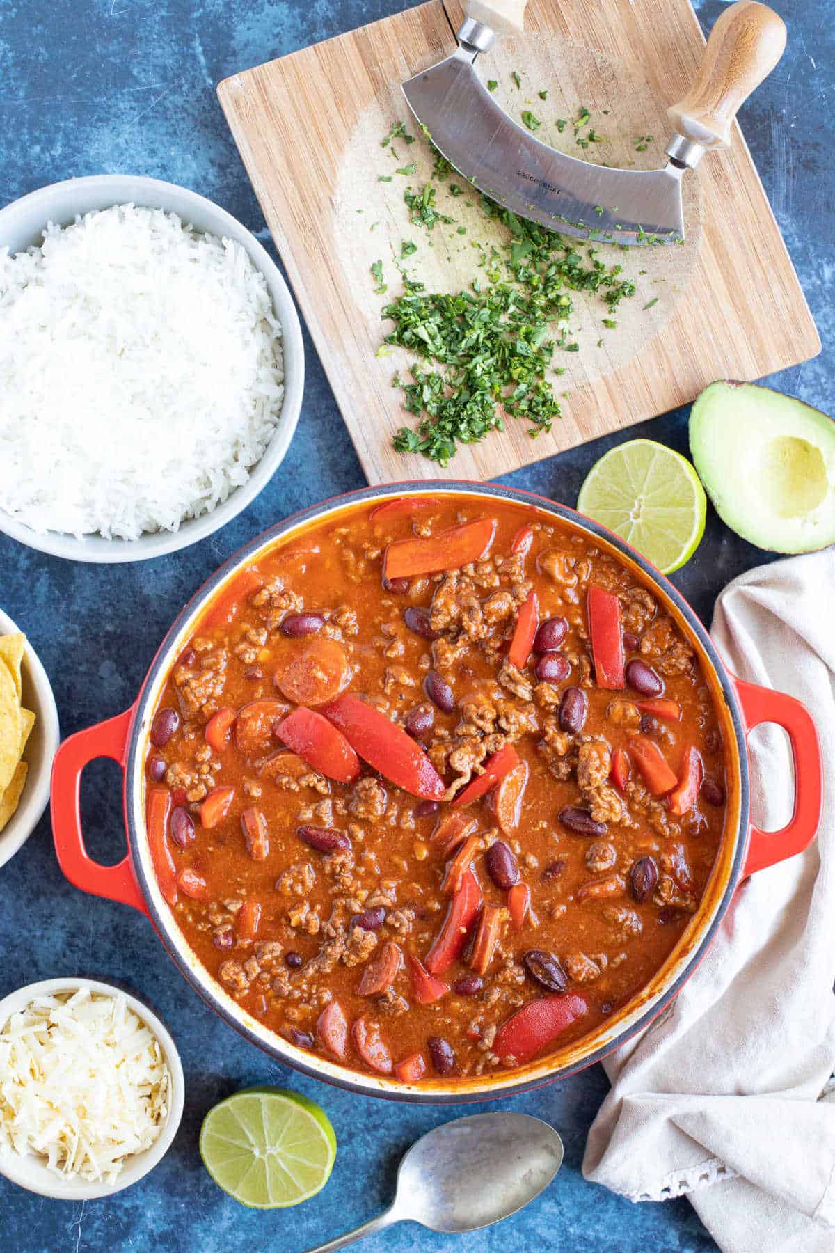 Mild chilli con carne in a red pan with rice.