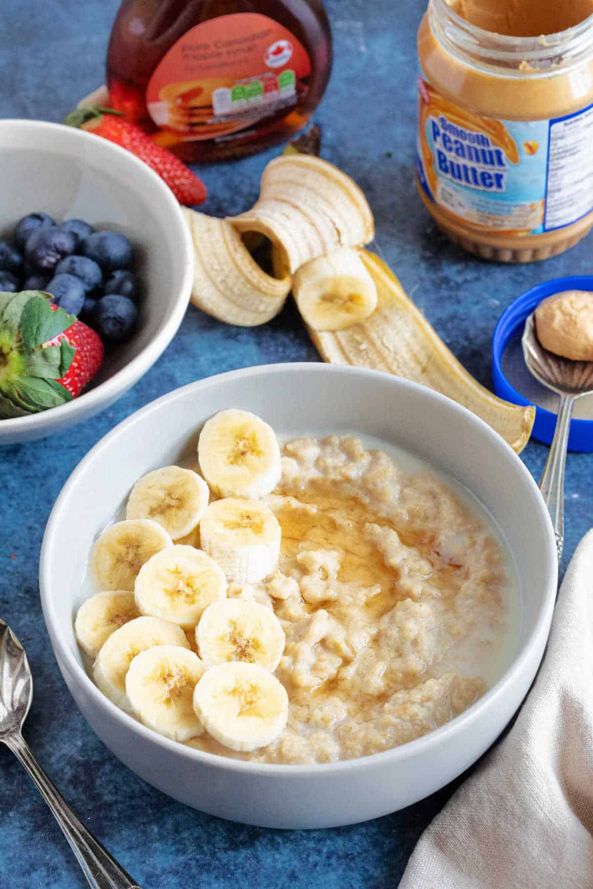 A bowl of peanut butter porridge with sliced banana.