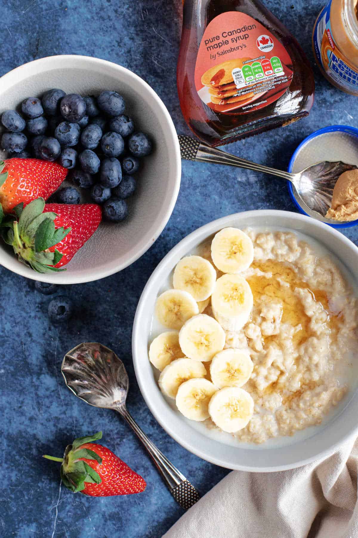 A bowl of peanut butter porridge. with fresh berries.