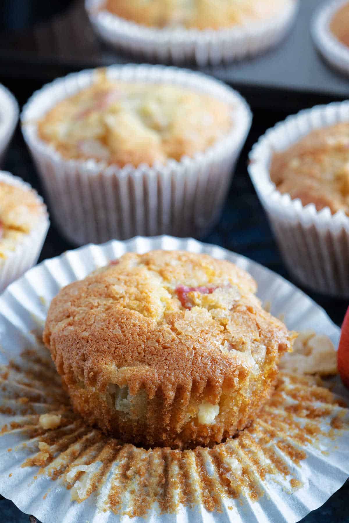 A rhubarb muffin with white chocolate chips.