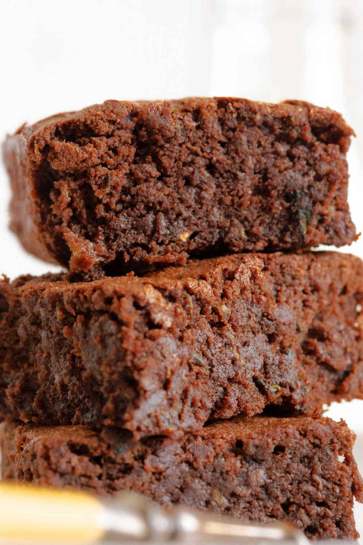 A close up photo of a chocolate courgette brownie.