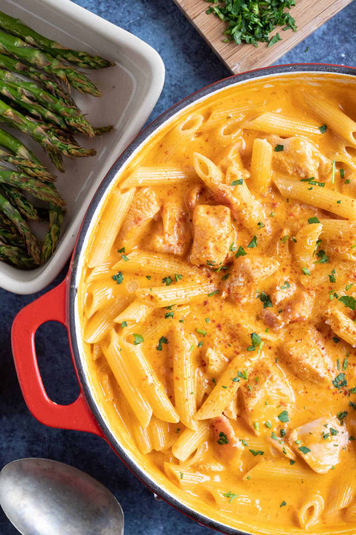 Paprika chicken pasta with a creamy sauce, served in a red pan.