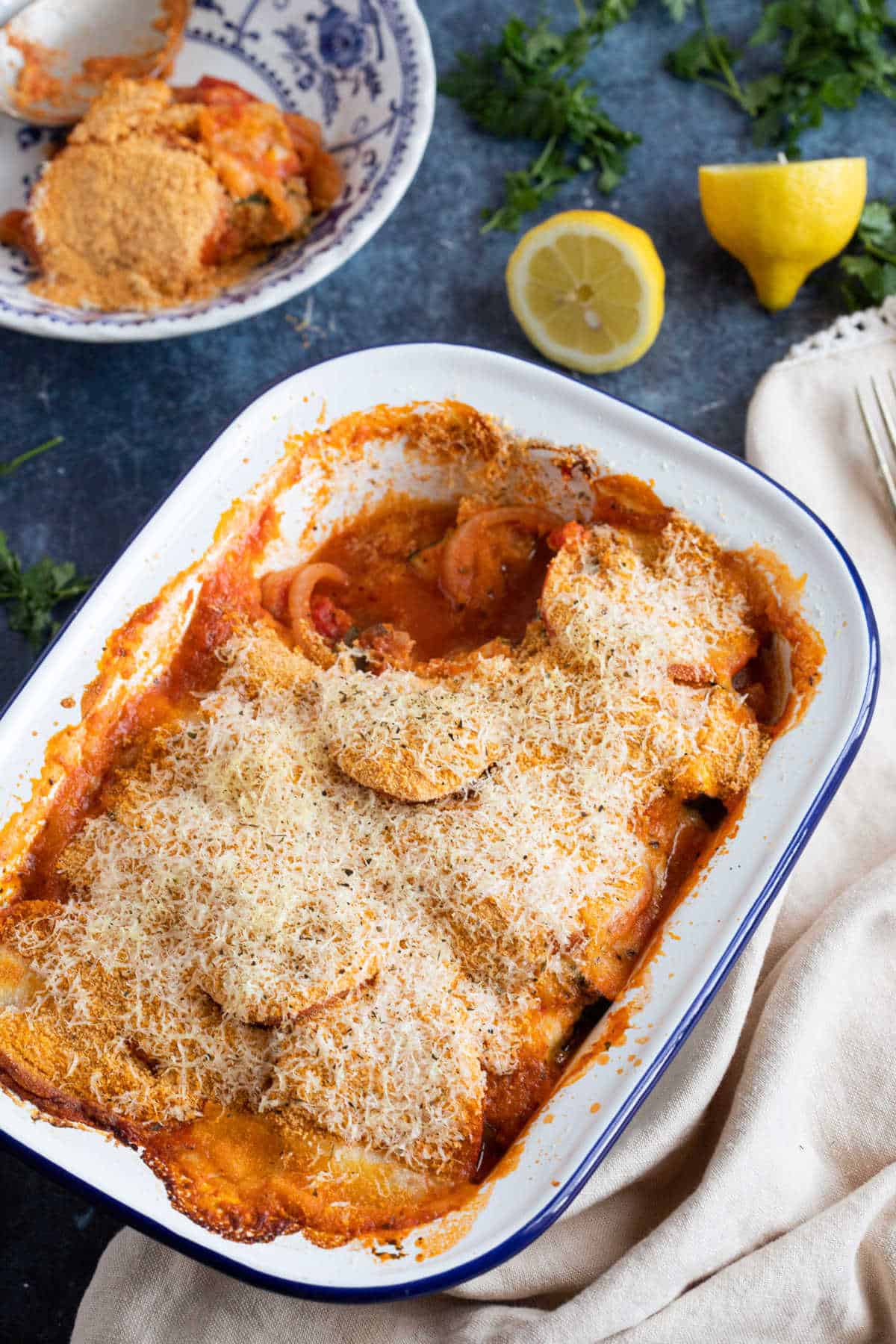 Courgette and tomato bake in an enamel pie dish.