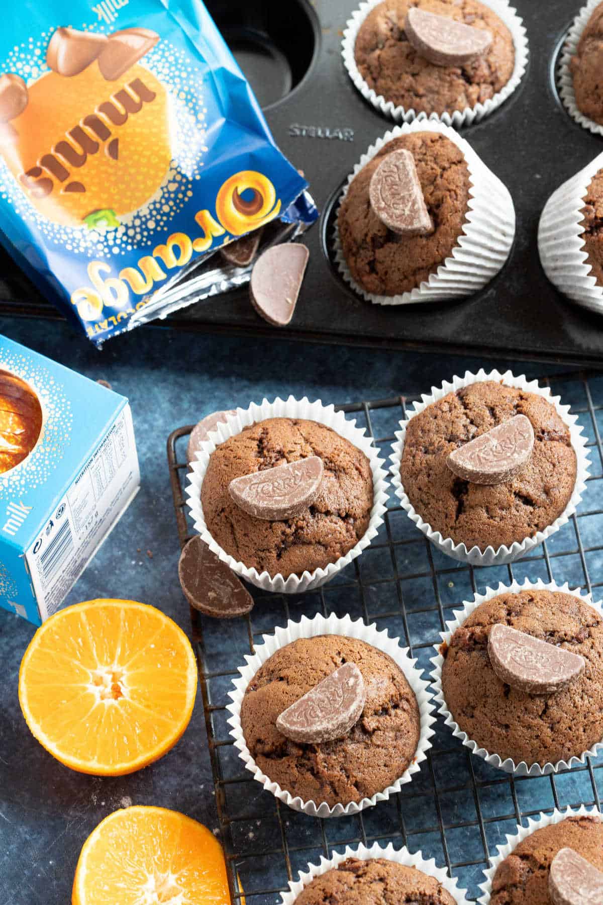 Chocolate orange muffins on a cooling rack.