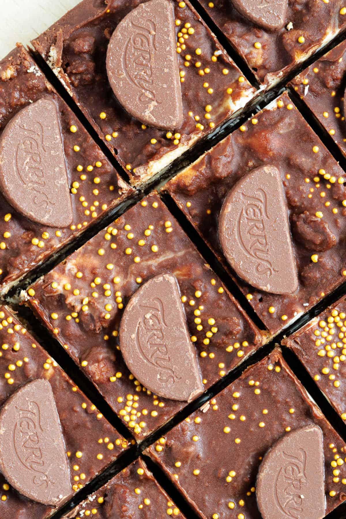 Sliced chocolate orange tiffin topped with chocolate orange minis.