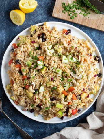 Curried rice salad on a white serving platter.